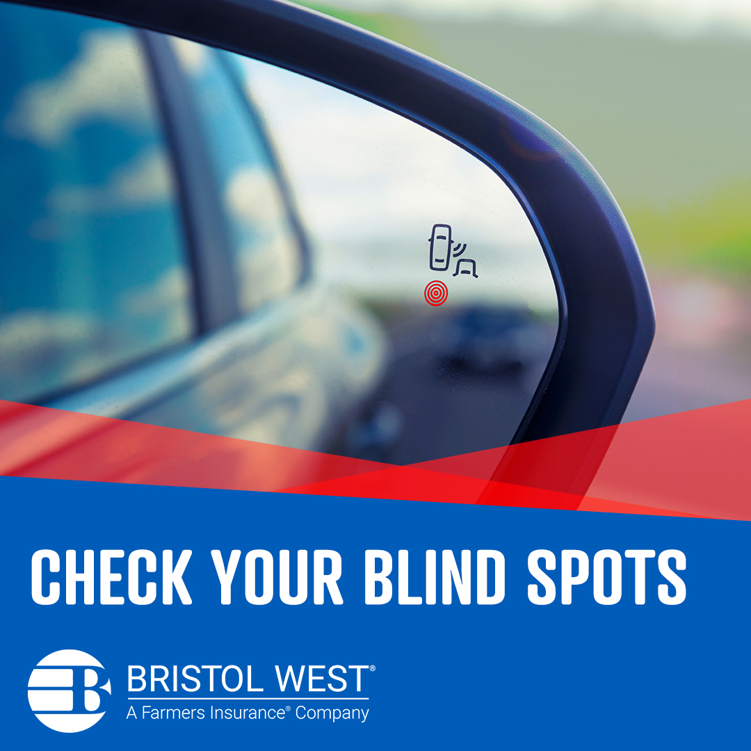 A car mirror with the blind spot sensor light on